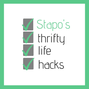The image shows the Stapo’s Thrifty Life Hacks logo. The name of the brand is listed out and before each word there is a green tick in a grey box. The logo has a green frame around it.